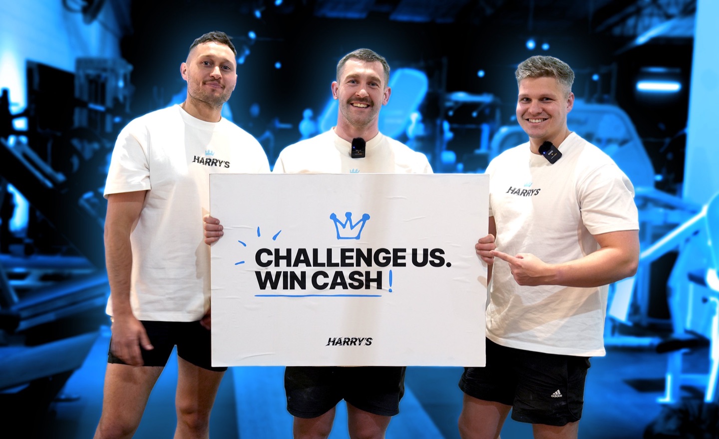 Hardcore Harry's founders holding a 'Challenge us. Win cash!' sign