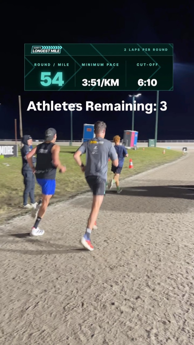 Live scoreboard showing round 54 with three athletes remaining as runners pass at night