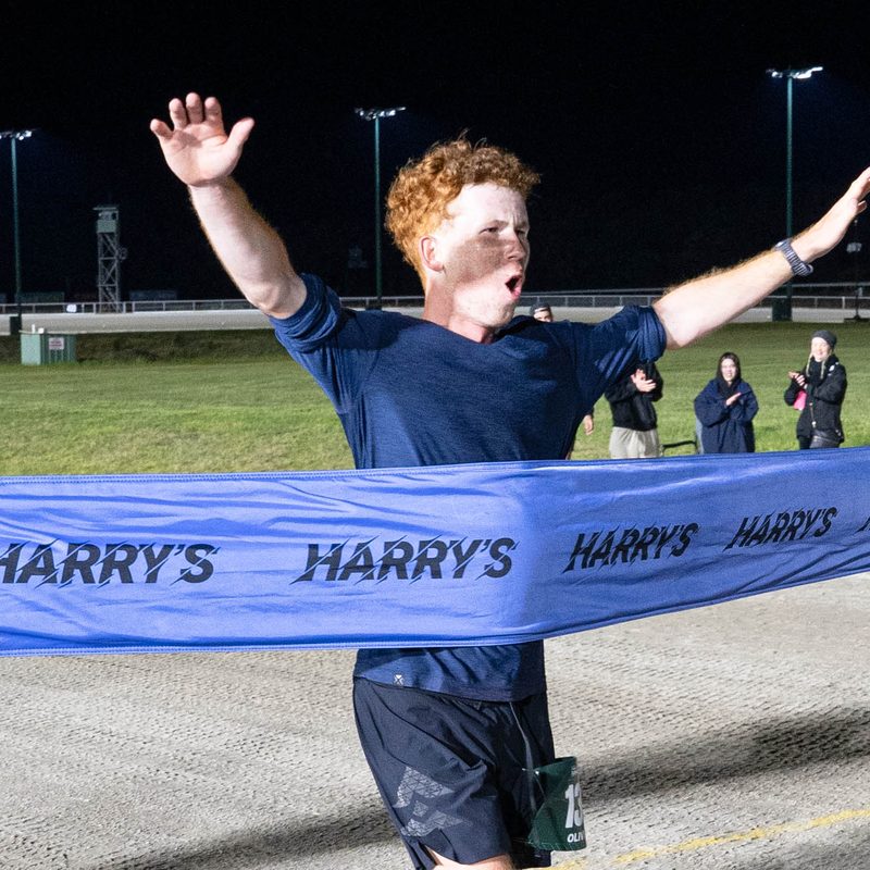 Oliver Sheekey crossing the line to win Harry's Longest Mile 2026